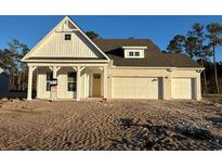 Two-story home with white siding, gray roof and two-car garage at 45 Northbrook Dr, Murrells Inlet, SC 29576