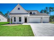 Charming new construction home with white siding, brick accents, and a spacious three-car garage at 45 Northbrook Dr, Murrells Inlet, SC 29576