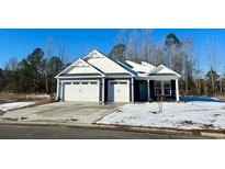 Two-car garage, white and blue exterior, partially snow covered lawn at 536 Sheepbridge Way, Loris, SC 29568