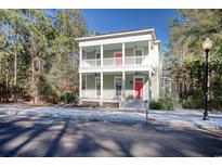 Two-story house with light green exterior, red door, and white columns at 55 Pineberry Dr., Georgetown, SC 29440