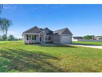 Newly built home with gray siding, attached garage, and grassy yard at Tbd Hodges Rd., Conway, SC 29527