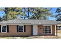Charming brick home featuring a well-maintained front yard and a classic, inviting entrance at 109 S Maple Ave., Andrews, SC 29510