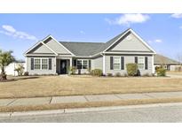 Gray house with a gray roof, black shutters, and a well-maintained lawn at 1105 Marley St., Conway, SC 29527