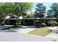 Front view of charming house with large garage and lush landscaping at 141 Twelve Oaks Dr. # 5, Pawleys Island, SC 29585