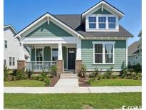 Charming green single-Gathering home with a well-manicured lawn and covered porch, capturing a cozy curb appeal at 1816 Tryon Dr, Myrtle Beach, SC 29588