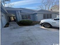 Gray house with attached garage and walkway at 1818 Topsail Ln., North Myrtle Beach, SC 29582