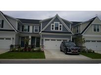 Two-story townhome with gray siding, two-car garage, and landscaping at 325 Golan Circle # 12B, Myrtle Beach, SC 29579