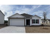 Charming single-story home featuring a two-car garage and beautifully landscaped front yard at 3450 Ashridge Way, Conway, SC 29526