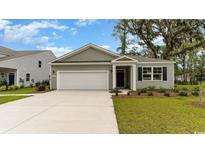New construction home with a two-car garage and well-manicured lawn at 4031 Smokey Dr, Conway, SC 29526