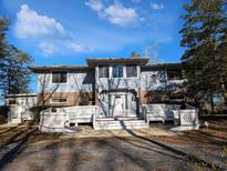 Two-story house with brick facade, white railings, and a double staircase at 462 Mohican Dr., Georgetown, SC 29440
