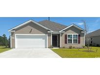 Charming single-story home with a two-car garage and well-maintained lawn at 5810 Ellisridge Ct, Conway, SC 29526
