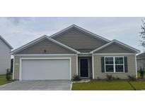 Charming single-story home featuring a two-car garage, neat landscaping, and neutral-toned siding at 6008 Fuller Ridge Ct, Conway, SC 29526