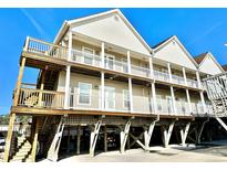 Three-story beach house with multiple balconies and parking underneath at 613 Sea Mountain Hwy. # 128, North Myrtle Beach, SC 29582