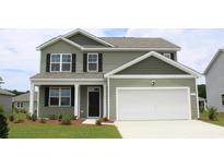 Two-story house with green siding, white garage door, and landscaping at 8059 Bear Claw Ct., Conway, SC 29526