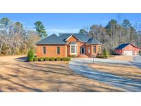 Brick home with a large front yard and a circular driveway at 2136 Bear Grass Rd., Longs, SC 29568