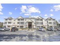 Two story condo building with ample parking and landscaping at 260 S Crow Creek Dr. # 18, Calabash, NC 28467