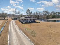 Aerial view of house, detached garage, and pond at 2647 Coats Rd., Loris, SC 29569