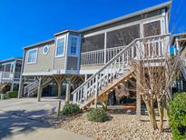 Elevated beach house with screened porch and stairs at 299 Lake Arrowhead Rd., Myrtle Beach, SC 29572