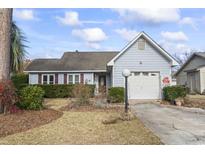 Ranch style home with attached garage and well-manicured lawn at 311 Flagstone Dr., Myrtle Beach, SC 29588