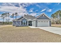 Newly constructed home with gray siding, two-car garage, and landscaped lawn at 340 William Nobles Rd., Aynor, SC 29511