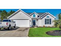 Nice curb appeal! This charming house features a two-car garage and a well-maintained lawn at 357 Encore Circle, Myrtle Beach, SC 29579