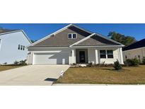 Attractive Craftsman style home with gray and beige siding, two-car garage, and manicured lawn at 386 Glacier Way, Conway, SC 29526