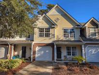 Two-story townhome with a garage and landscaping at 437 Red Rose Blvd. # 5, Pawleys Island, SC 29585