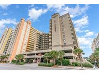 Oceanfront building with parking and palm trees at 501 S Ocean Blvd. # 404, North Myrtle Beach, SC 29582