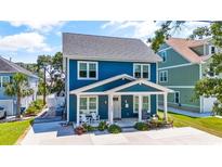 Two-story blue house with white trim and a front porch at 5907 Haskell Circle, Myrtle Beach, SC 29572