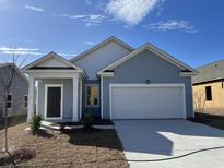 Newly constructed home with gray siding, two-car garage, and landscaping at 616 Muster Field Ct., Conway, SC 29526