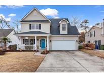 Two-story house with attached garage and landscaped lawn at 637 Sparrow Dr., Surfside Beach, SC 29575