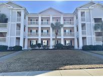 Attractive three-story building with light pink accents and balconies at 638 Waterway Village Blvd. # 16G, Myrtle Beach, SC 29579