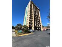 Ocean Dunes Tower II condo building, featuring a multi-story structure with balconies and ample parking at 7500 N Ocean Blvd. # 6145, Myrtle Beach, SC 29572