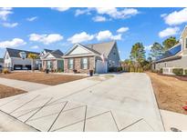 Charming single-Gathering home featuring stone accents, a spacious driveway, and an attached garage at 980 Desert Wheatgrass Dr., Myrtle Beach, SC 29579
