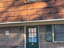 Brick building exterior with a dark green door and wood shake roof at 1025 Carolina Rd. # Ee-3, Conway, SC 29526