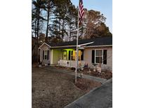 Charming one-story home with landscaped yard and American flag at 106 Fonza St., Conway, SC 29526