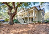 Two-story condo building with stairs, balconies, and landscaping at 14 Stillwood Dr. # 2, Pawleys Island, SC 29585