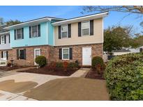 Brick townhouse with two-toned exterior and landscaping at 214 13Th Ave. S # C, Surfside Beach, SC 29575