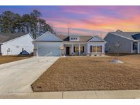 Craftsman style home with white siding, brick accents, and a two-car garage at 280 Hayloft Circle, Conway, SC 29526