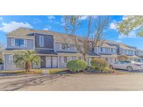 Gray siding townhouses with a paved driveway and landscaping at 3700 Golf Colony Lane # 20-L, Little River, SC 29566