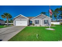 One-story home with gray siding, two-car garage, and manicured lawn at 575 Mossbank Loop, Longs, SC 29568