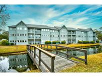 Building exterior with water view and wooden footbridge at 5905 South Kings Hwy. # 6310-D, Myrtle Beach, SC 29575