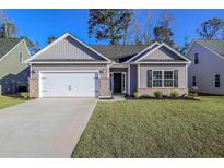 New construction home with a two-car garage and landscaped lawn at 622 Lightwood Dr., Conway, SC 29526