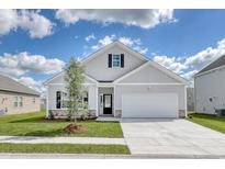 Charming single-Gathering home with a well-manicured lawn and a two-car garage at 705 Lambeth Ln., Conway, SC 29526