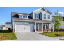 Charming two-story home with a white garage door, and manicured lawn, perfect for Gathering living at 808 St. Albans Loop, Conway, SC 29526
