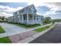 Gray two-story home with white porch and landscaping at 8091 Laurel Ash Ave., Myrtle Beach, SC 29572