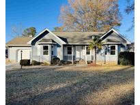 Gray house with a landscaped yard and attached garage at 104 Willow Ridge Rd., Myrtle Beach, SC 29588