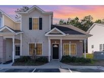 Two-story townhome with neutral siding and landscaping at 107 Maddux Ln. # E, Myrtle Beach, SC 29588