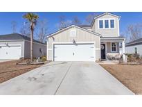 Two-story house with a white garage door and landscaping at 136 Timber Oaks Dr., Myrtle Beach, SC 29588