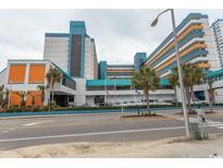 Landmark oceanfront resort building with parking and palm trees at 1501 S Ocean Blvd. # 1542, Myrtle Beach, SC 29577